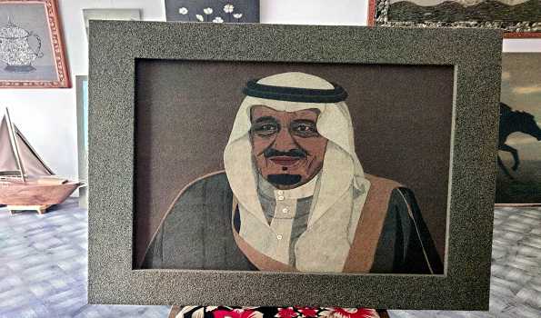 Manzoor Bhat is a lone artist who uses coloured stones to create a scene on ply board.