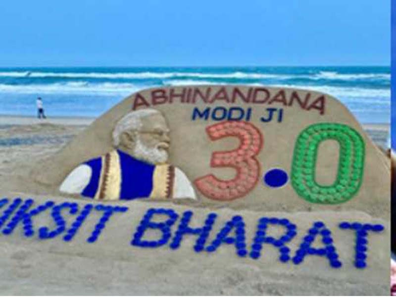 At Puri beach, sand artist Sudarshan crafts a sculpture of Modi.