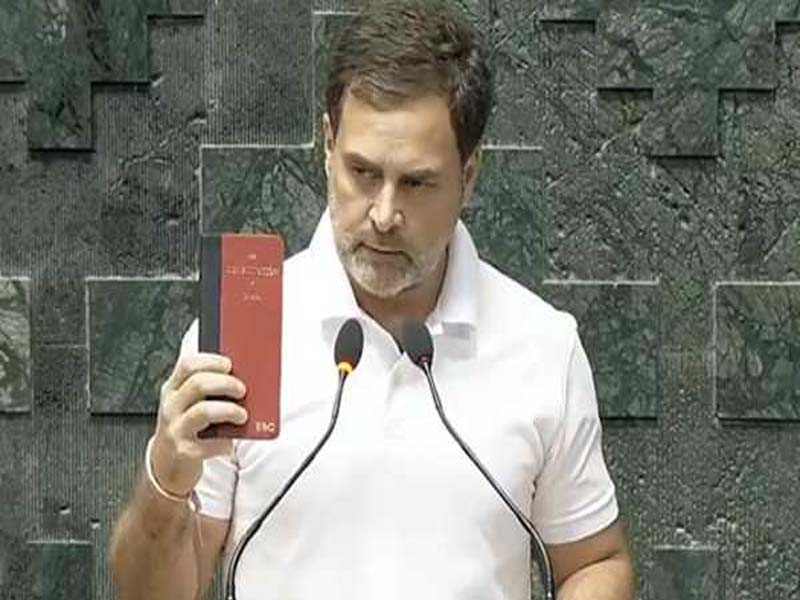 Rahul Gandhi takes his oath holding a copy of the Constitution.
