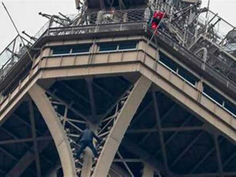 Before the Olympics close, a man climbs the Eiffel Tower and is arrested.