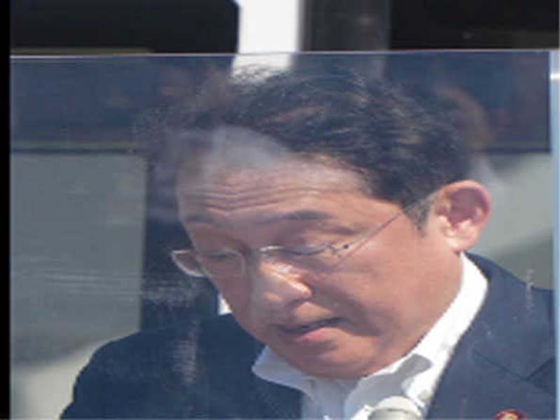 Japan’s prime minister discusses security concerns behind bulletproof glass.
